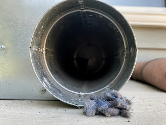 Abington Dryer Vent Cleaning technician using specialized equipment to clear severe dryer vent blockage in Abington